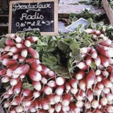Bountiful display of Heirloom Organic French Dressing Radish with a chalkboard sign in the background