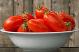 Bowl of Heirloom Organic Big Mama Tomat on a wooden surface