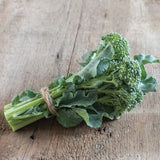 Bunch of Heirloom Organic Broccoli De Ciccoon a wooden surface