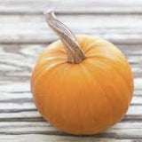 Heirloom Organic Small Sugar Pumpkin on a wooden surface