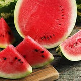 Watermelon slices on a wooden cutting board with a dark background