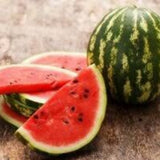 Watermelon with slices on a wooden surface