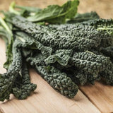 Heirloom Organic Black Magic Lacinato Kale on a wooden cutting board