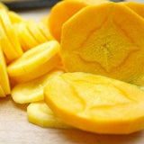 Sliced Heirloom Organic Solar yellow Carrot on a textured surface