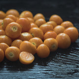 Close-up of Heirloom Organic Cape Gooseberry Seeds  Aka Physalis peruviana, Golden Berry, Rasbhari, Peruvian Groundcherry, Poha on a dark surface