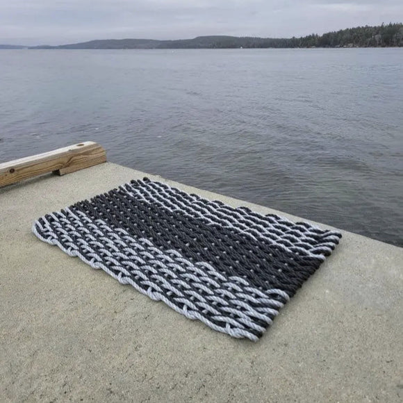 Textured rug on a dock by a body of water