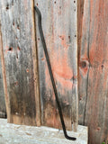 Black Dragon Fire Poker against a wooden background