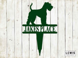 Green metal sign with dog silhouette and 'Jakes Place' text on a wooden background, Lewis Design Company branding visible.