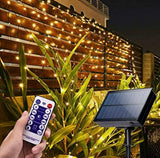 Solar string lights with remote control on a garden wall at night