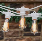 String of vintage-style light bulbs with a brick wall background