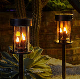 Two solar-powered outdoor lights with a warm glow, set against a natural background.