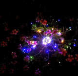 Decorative string lights with flowers on a dark background