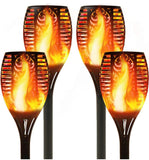 Four solar-powered flame lights on a white background