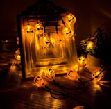Halloween-themed string lights with jack-o'-lantern design around a decorative frame.