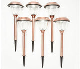 Set of six copper-colored solar garden lights on a white background