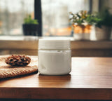 White jar on a wooden surface with a blurred indoor background