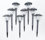Set of solar-powered outdoor lights on a white background