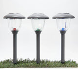 Three solar-powered garden lights on grass with a white background