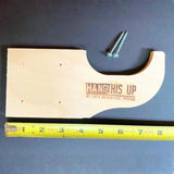 Wooden bracket with screws and 'Hang This Up' branding on a blue background