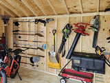 Storage shed interior with tools and equipment on wooden walls