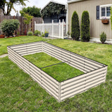Metal raised garden bed on a grassy lawn with a house and fence in the background