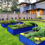 Blue raised garden beds with plants in front of a house