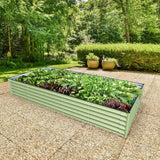 Green metal raised garden bed with plants in a garden setting
