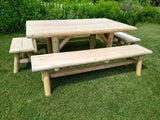 Wooden picnic table with benches on a grassy area