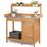 Wooden potting bench with metal countertop, storage drawers, and planters on a white background