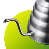 Metallic kettle with a curved spout on a green background