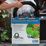 Raised bed drip watering kit with packaging held by a person outdoors. Watering - Raised Bed Drip Irrigation Kit
