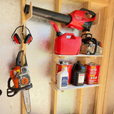 Wooden tool rack with power tools and supplies in a workshop setting