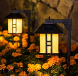 Solar-powered outdoor lanterns with warm glow in a garden setting.