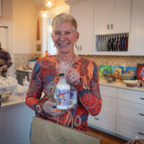 Woman holding a bottle of LAVENDER GOATS MILK LOTION