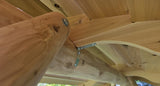 Close-up of wooden beams with metal brackets in an outdoor setting Wooden Porch Swing with Canopy