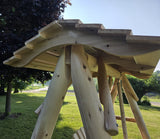 Swing Canopy for HD Swing with a curved roof in an outdoor setting