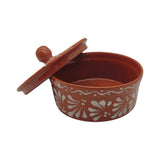 Terracotta container with floral patterns and a lid on a white background