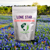 Bag of Lone Star Native Wildflower Mix in front of a field of bluebonnets