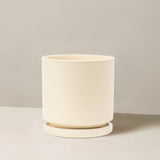 Beige ceramic planter on a neutral background