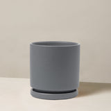 Gray planter on a beige surface with a neutral background