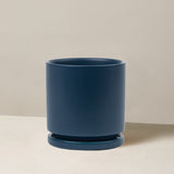 Blue planter on a beige surface with a neutral background