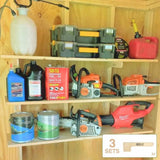 Wooden shelf with tools, including chainsaws and storage boxes, against a wooden wall.