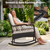 A woman sits in a dark wicker rocking chair with cream cushions in a garden patio setting. The image includes text reading 'Smooth & Safe Rocking Motion' and a feature inset showing front and rear anti-tip stoppers and anti-slip rubber strips.