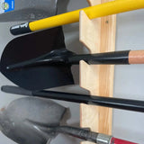 Set of shovels with yellow handle on a wooden holder against a gray background Wall-Mounted Garden Tool Rack - Garage
