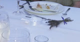 Table setting with a bouquet of lavender on a white tablecloth