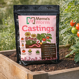 Bag of Meme's Worm Castings in a garden setting with plants and tomatoes.